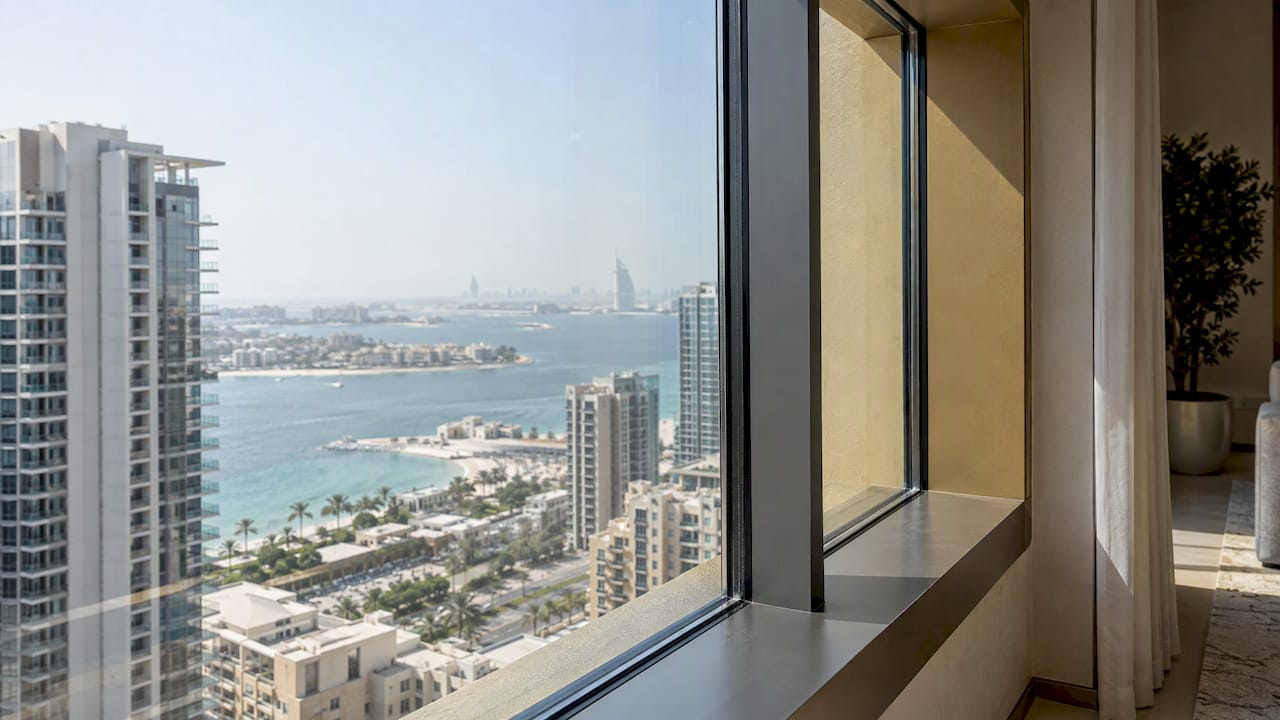 Apartment glazing beside a shaded balcony reveal